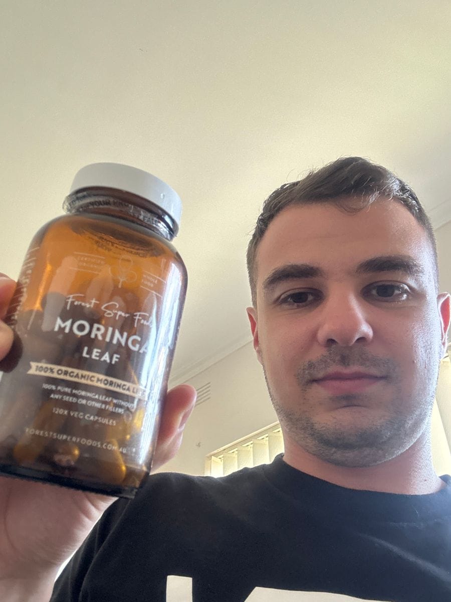 Customer showcasing Forest Super Foods Moringa Capsules while sharing feedback.